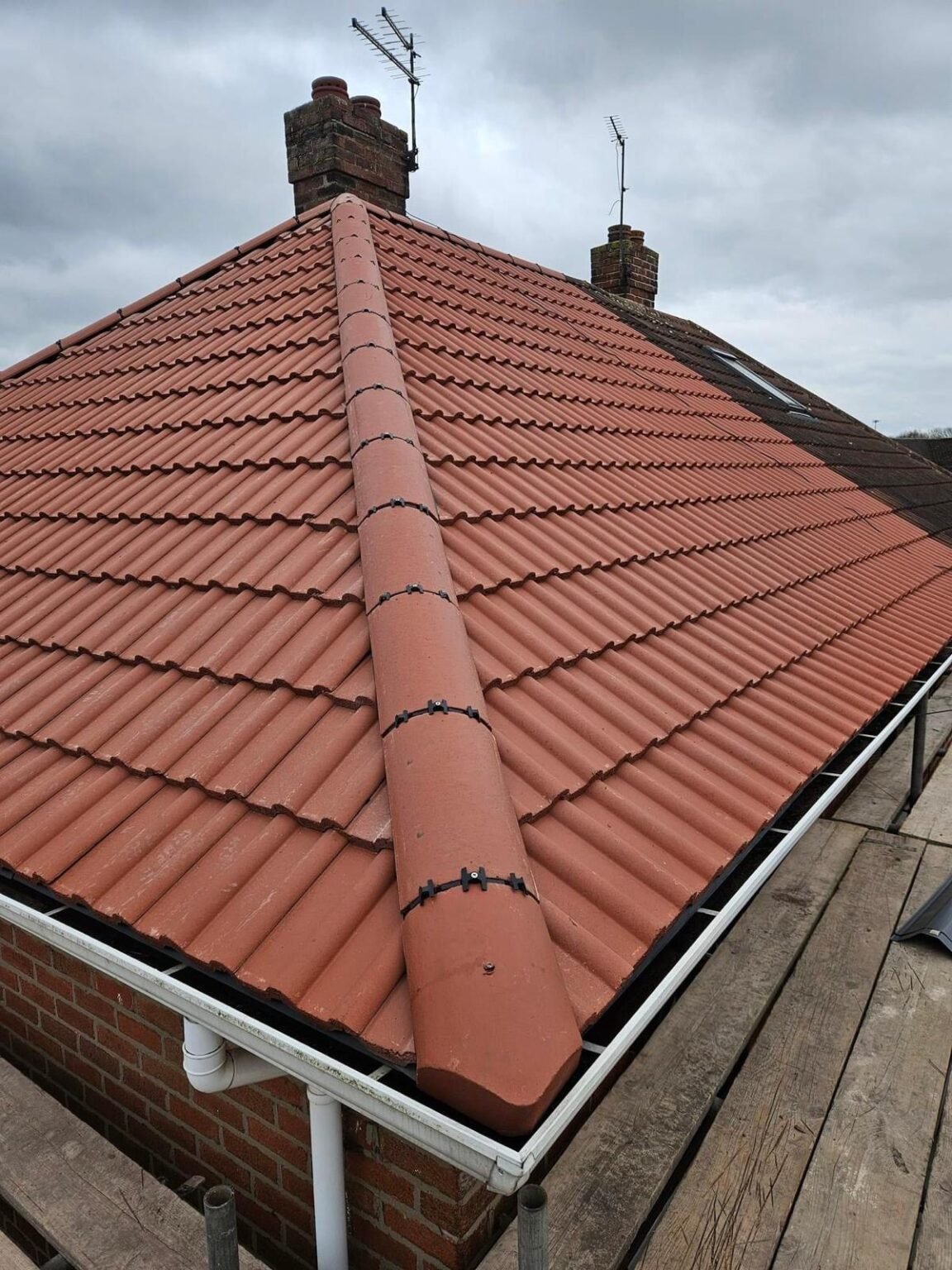 Red tile hip roof with Velux skylights, Hampstead