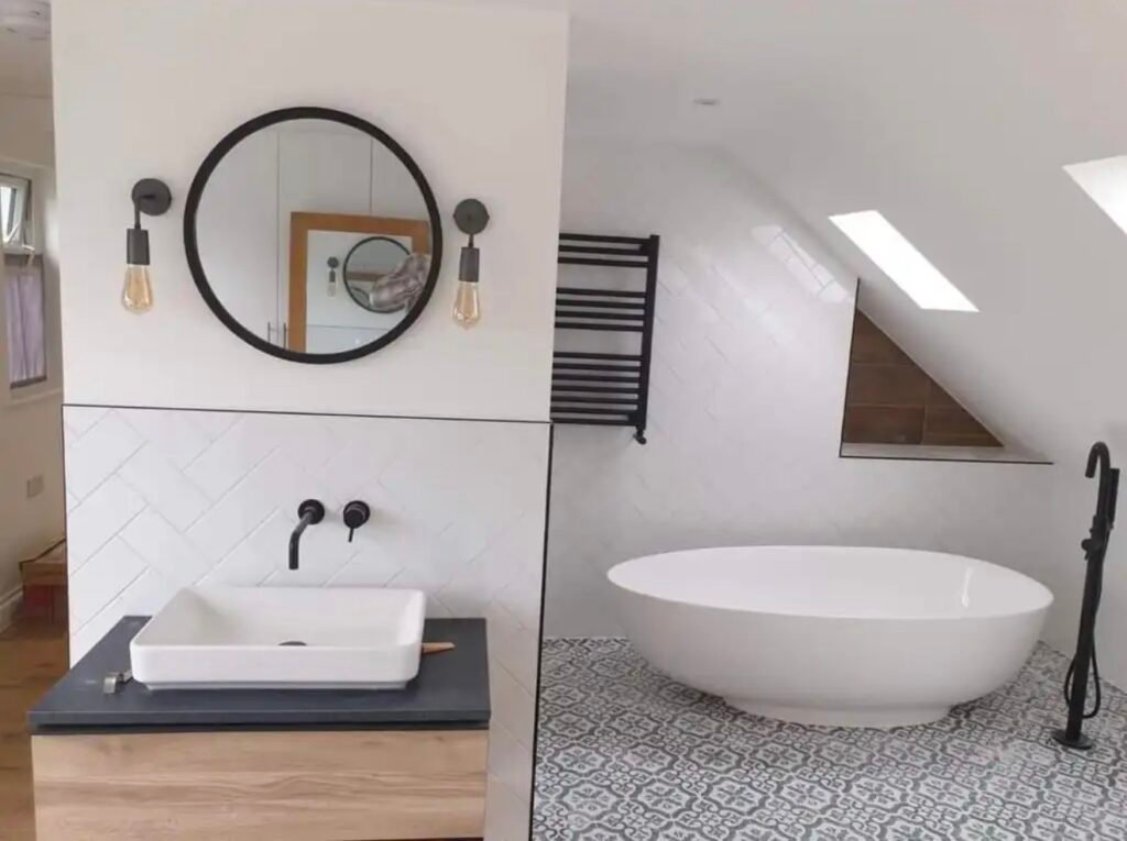 Renovated bathroom with large-format stone-effect tiles, a bath with glass screen and a wall-hung oak vanity